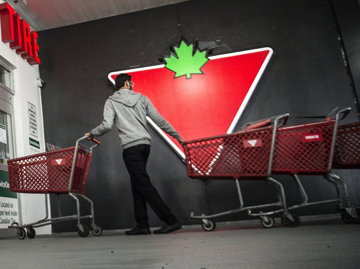An employee enters a Canadian Tire Corp. store at the company's Lakeshore Boulevard East and Leslie Street location in Toronto, Ont.