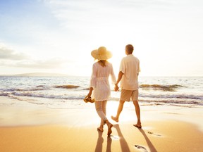 Happy Romantic Middle Aged Couple Enjoying Beautiful Sunset Walk on the Beach. Travel Vacation Retirement Lifestyle Concept getty