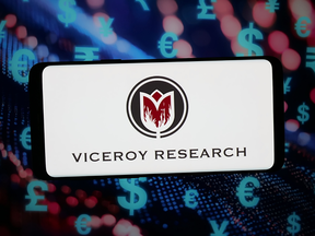 In this photo illustration, the logo of US company Viceroy Research LLC is displayed on a smartphone in front of abstract background on computer screen.