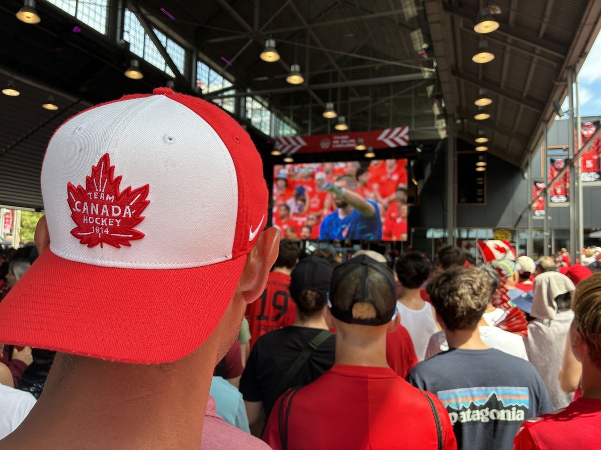 A fan wearing a Canada hat watches on as the Canada-Switzerland World Cup 2026 Group B match gets underway on the big screen at the Canada Soccer House fan zone in North Vancouver, B.C. on June 24, 2026.