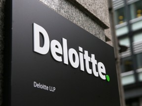 A Deloitte logo is pictured on a sign outside the company's offices in London on September 25, 2017.