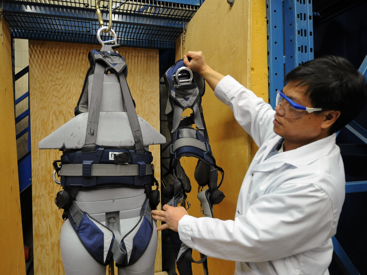 A CSA testing employee checks to see if a safety harness passed the fall test with a 350pound dummy inside for weight. in an onsite testing facility of CSA Group, a leading product certification and testing company in Rexdale.
