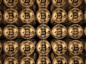This illustration photograph shows a screen displaying Bitcoin logos, in Mulhouse on December 5, 2025.