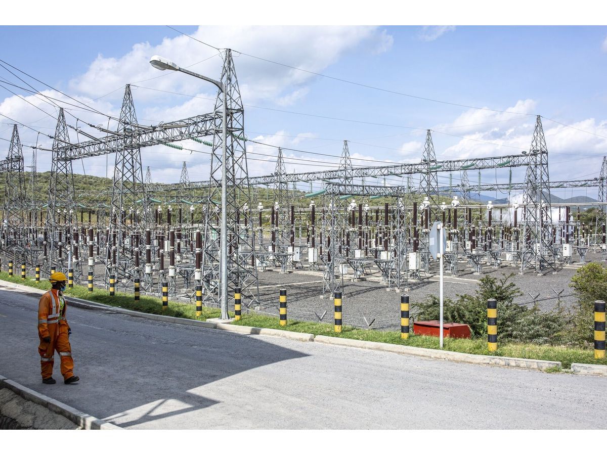 A worker passes an electricity substation at the Olkaria Geothermal Complex, operated by Kenya Electricity Generating Company Plc in Hells Gate National Park in Naivasha.