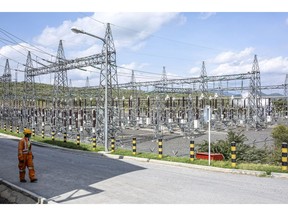 A worker passes an electricity substation at the Olkaria Geothermal Complex, operated by Kenya Electricity Generating Company Plc in Hells Gate National Park in Naivasha.