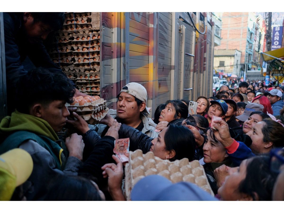 Residents wait in line for food amid shortages in La Paz, on June 3.