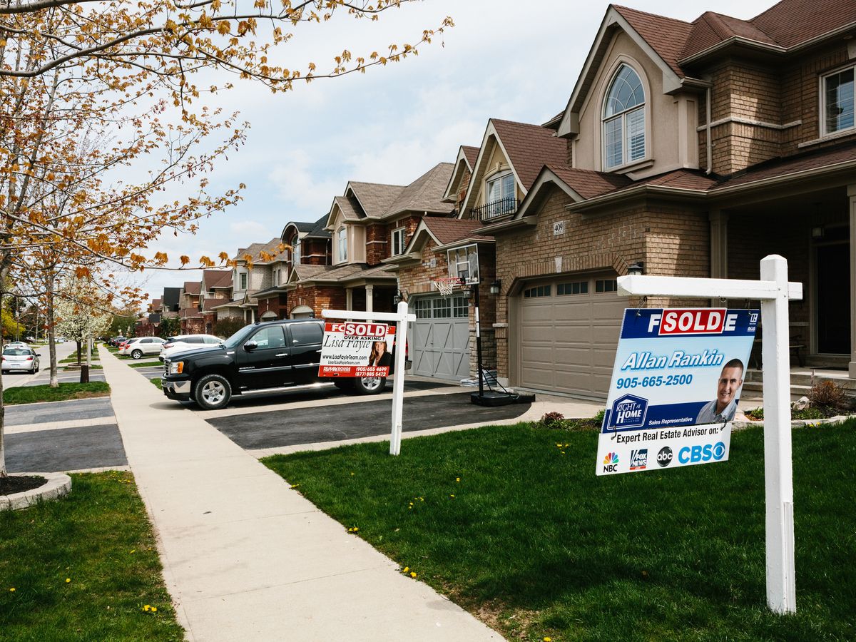'Sold' signs are displayed outside of homes in Whitby, Ont.
