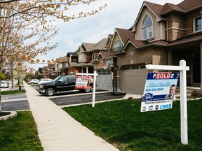 'Sold' signs are displayed outside of homes in Whitby, Ont.