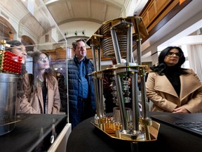 Guests examine quantum technology components during a media announcement highlighting new developments in Canada’s quantum sector at the University of Saskatchewan. Photo taken in Saskatoon, Sask. on Tuesday, March 31, 2026.