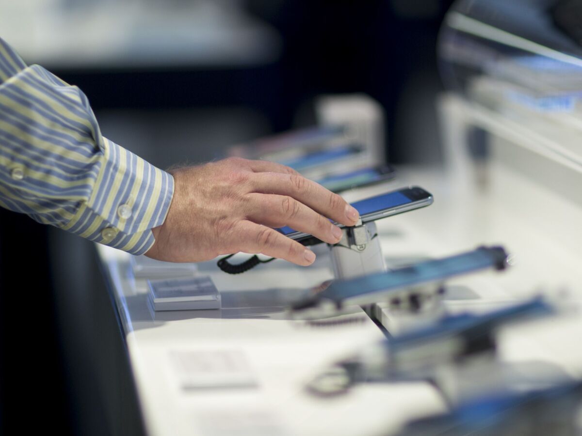 A customer browses mobile phones at a Bell Canada store in Toronto, Ontario, Canada, on Wednesday, June 22, 2016
