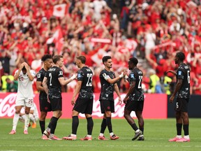 Players of Canada celebrate the team's 6-0 victory in the FIFA World Cup 2026 Group B match between Canada and Qatar at BC Place Vancouver on June 18, 2026 in Vancouver, British Columbia.