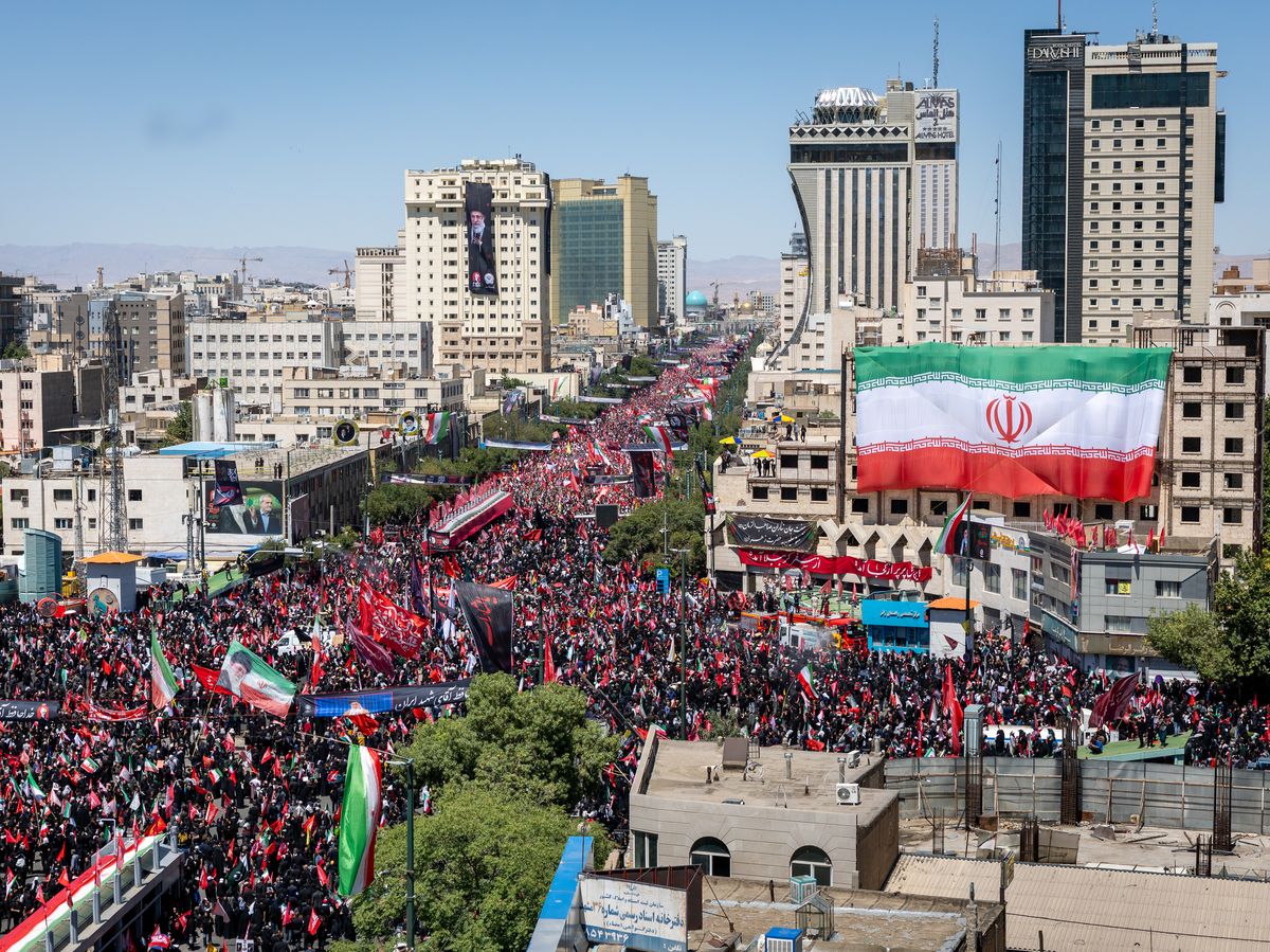 Thousands of mourners await the arrival of the body of Iran's slain Supreme Leader Ayatollah Ali Khamenei on July 09, 2026 in Mashhad, Iran.