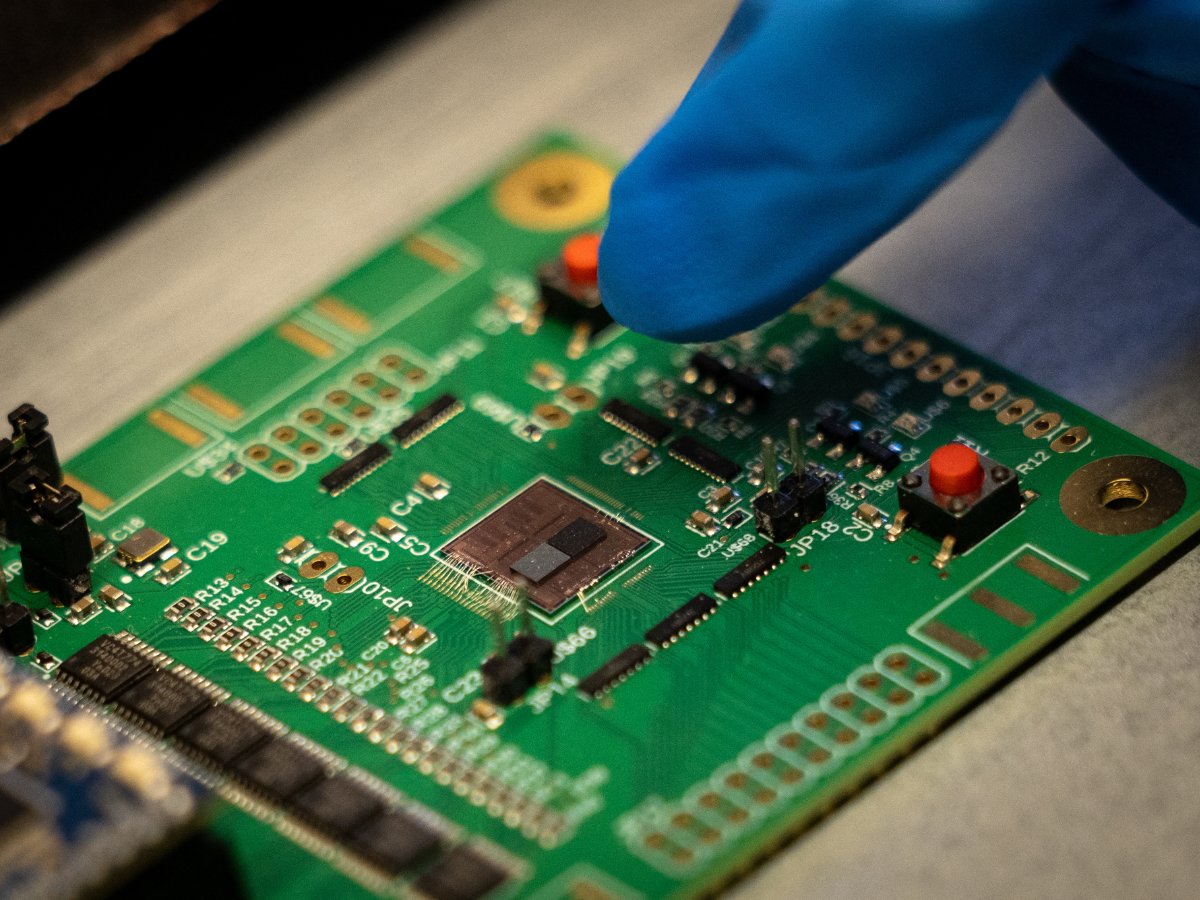 UCLA PhD Student in electrical engineering, Samuel Wang, points at chiplets diplayed on a semiconductor wafer at the Center for Heterogeneous and Performance Scaling laboratory during the official launch of the Semiconductor Hub at the UCLA Samueli School of Engineering in Los Angeles, on May 21, 2026.
