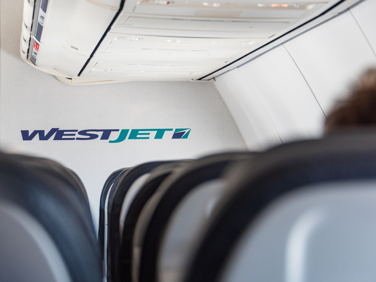 Interior of a Westjet plane. WestJet Airlines Ltd. is a Canadian low-cost carrier that provides scheduled and charter air service to 100 destinations in Canada.