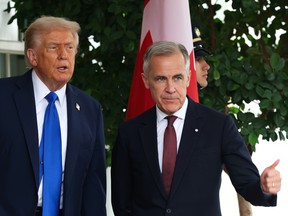 U.S. President Donald Trump (L) welcomes Canadian Prime Minister Mark Carney outside the West Wing of the White House on October 07, 2025 in Washington, DC.