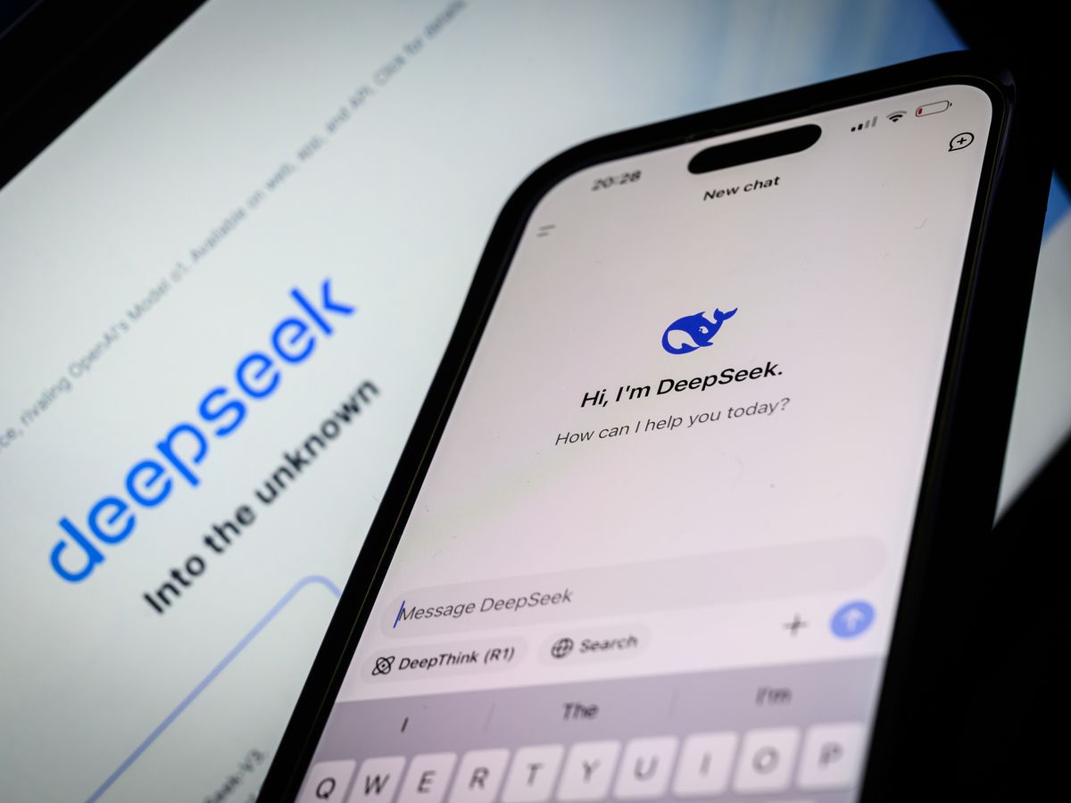 In this photo illustration, the Deepseek search page is displayed on a mobile phone in front of a laptop screen displaying the Deepseek homepage, on January 29, 2025 in London, England.