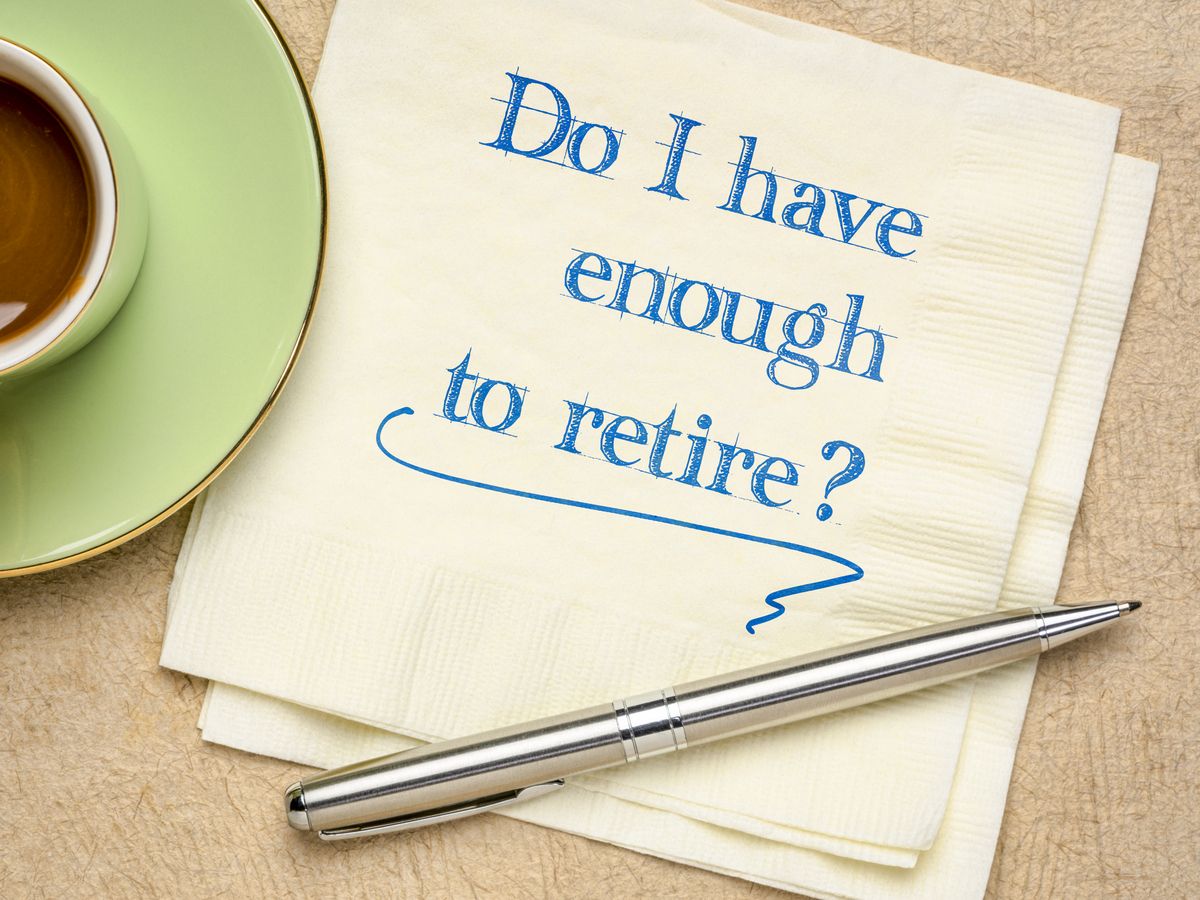 Do I have enough to retire? Handwriting on a napkin with a cup of coffee. Finance and retirement planning concept