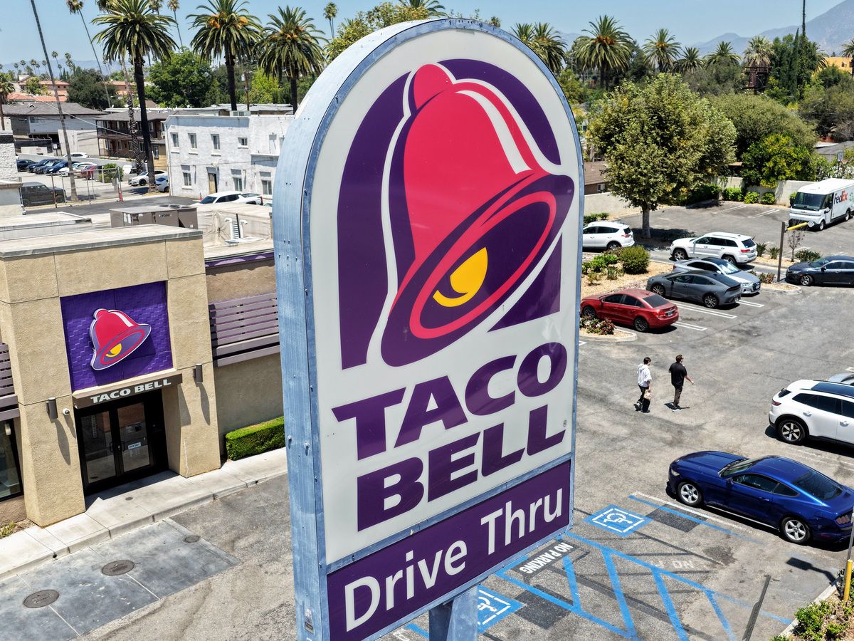 In an aerial view, customers depart a Taco Bell restaurant on July 14, 2026 in Pasadena, California.