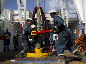 Employees torque a pipe at a wedge well at Christina Lake, a situ oil production facility half owned by Cenovus Energy Inc. and ConocoPhillips, in Conklin, Alberta, Canada