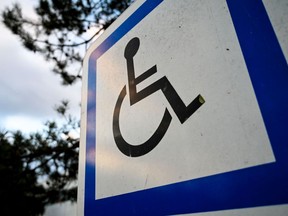 This file photograph taken on September 17, 2019, shows a sign indicating a parking space for vehicles of persons with reduced mobility at the entrance to a car park near Lille, northern France.