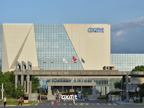 People walk past the headquarters of ChangXin Memory Technologies (CXMT) in Hefei, in China's eastern Anhui province on July 16, 2026.