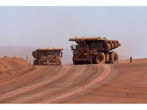 Autonomous haul trucks move along a haul road at Rio Tinto Group's Gudai-Darri iron ore mine in the Pilbara region of Western Australia, on Thursday, Oct. 19, 2023. Rio Tinto Group, BHP Group Ltd. and Fortescue Metals Group Ltd. produce almost two-thirds of the world's seaborne iron ore from Western Australia, and margins remain enviable. For the first time in a generation, though, the specter of disruption looms over mining's most reliable profit generator.