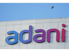 The Adani Group signage atop the company's headquarters in Ahmedabad, India, on Monday, Nov. 3, 2025. Adani Enterprises Ltd. is planning to raise as much as 250 billion rupees ($2.8 billion) through a rights issue as it seeks to invest in capital intensive businesses like its airports venture.