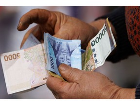 A vendor holds South Korean won banknotes at the Bukbu Market ahead of Lunar New Year in Iksan, Jeollabuk Province, South Korea, on Saturday, Feb. 14, 2026. The South Korean won is expected to strengthen this year on solid growth momentum, bond index inclusion and the end of the monetary easing cycle, according to BMI.
