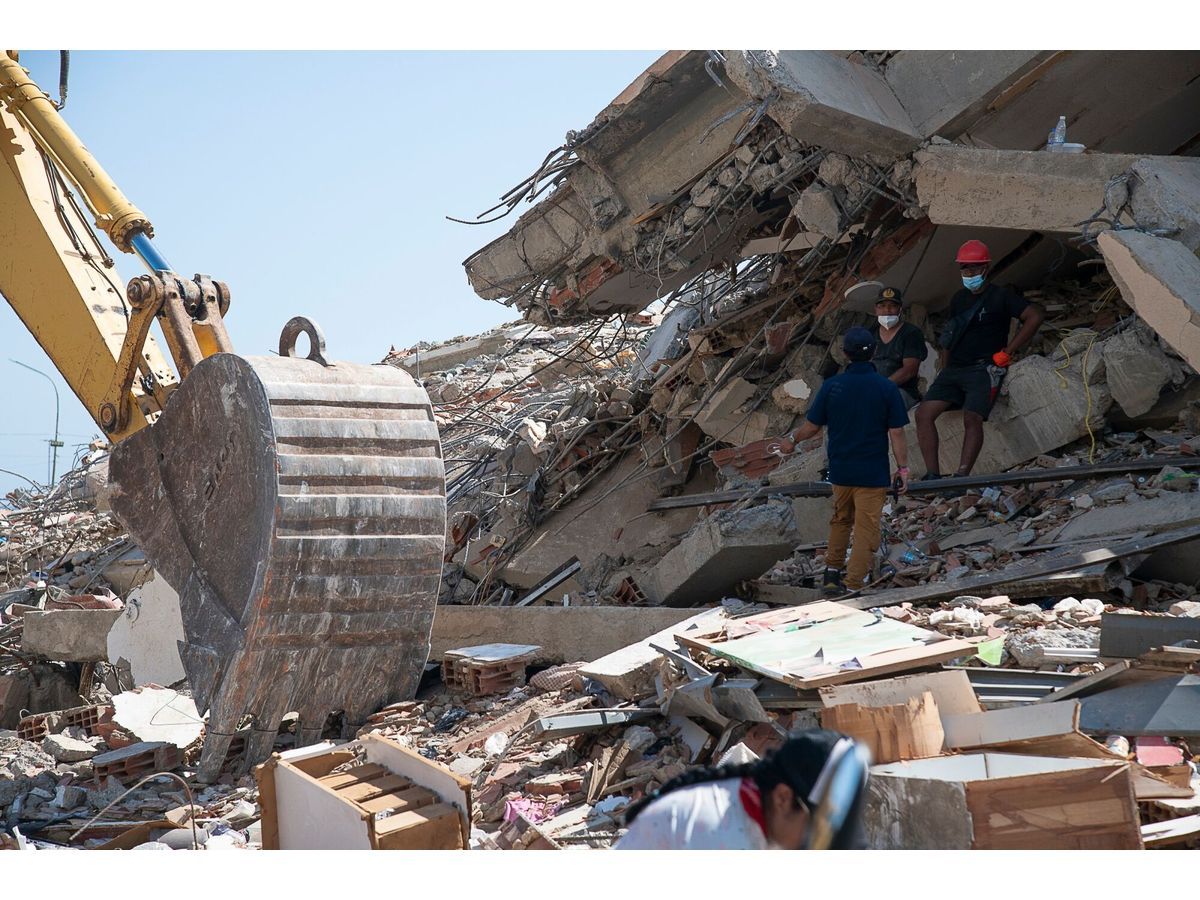 Heavy machinery and rescue workers in search of survivors in destroyed buildings in Los Corales, La Guaira state, Venezuela on July 1.