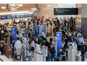 Southwest Airlines passengers checking in at San Francisco International Airport in July. Airlines are turning to AI to make their dynamic pricing methods more efficient.