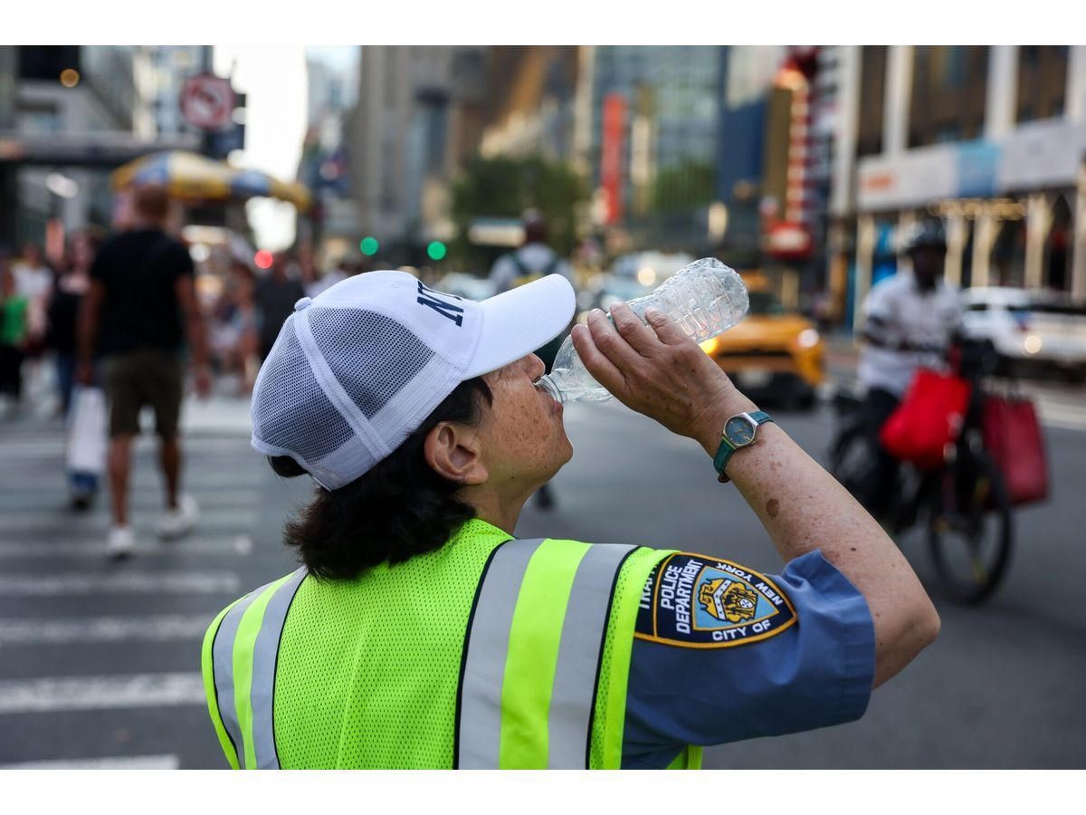 A New York Police Department (NYPD) traffic officer drinks water during high temperatures in New York, US, on Friday, July 3, 2026.