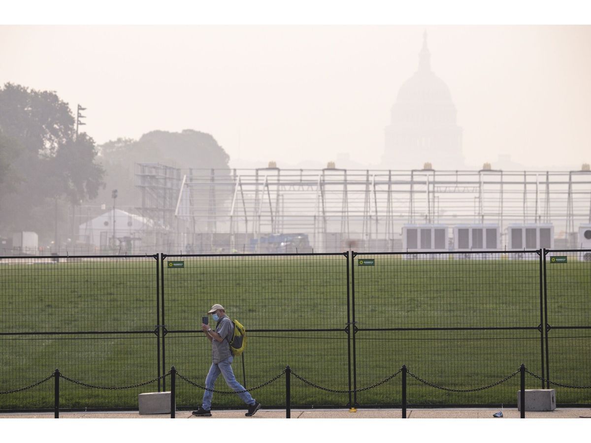 Smoke from massive wildfires in Canada reduce visibility and cast a haze over the Capitol in Washington on July 17.