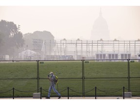 Smoke from massive wildfires in Canada reduce visibility and cast a haze over the Capitol in Washington on July 17.