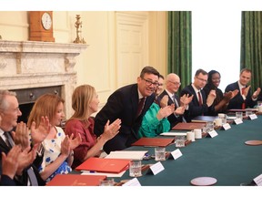 Andy Burnham, UK prime minister, center, takes his seat with ministers during his first cabinet meeting inside 10 Downing Street in London, UK, on Tuesday, July 21, 2026. The UK will scrap a 5% tax on energy bills starting from October, Burnham announced, the first of several policies expected to offer households more