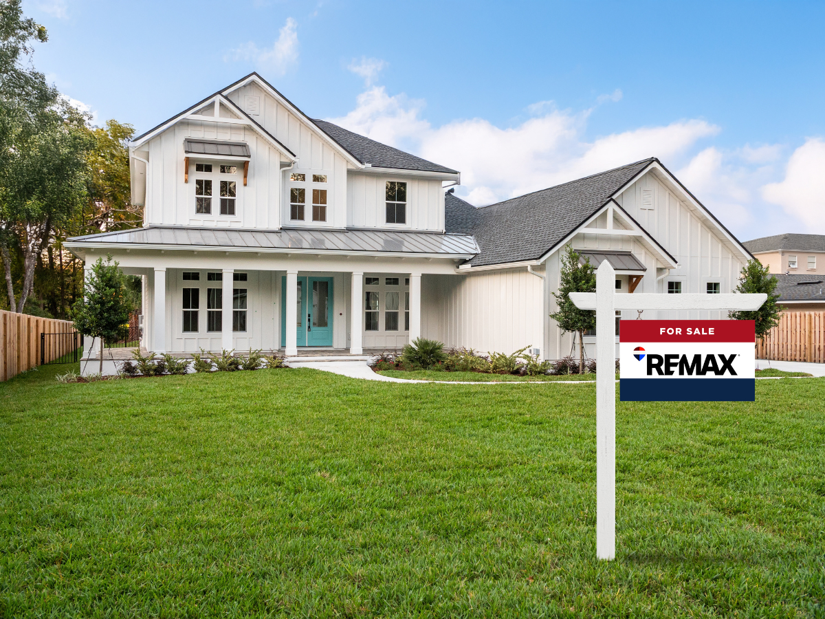 REMAX "For Sale" signs in front of a home.