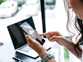 Data information concept, Young woman waiting for cloud uploading on smartphone.