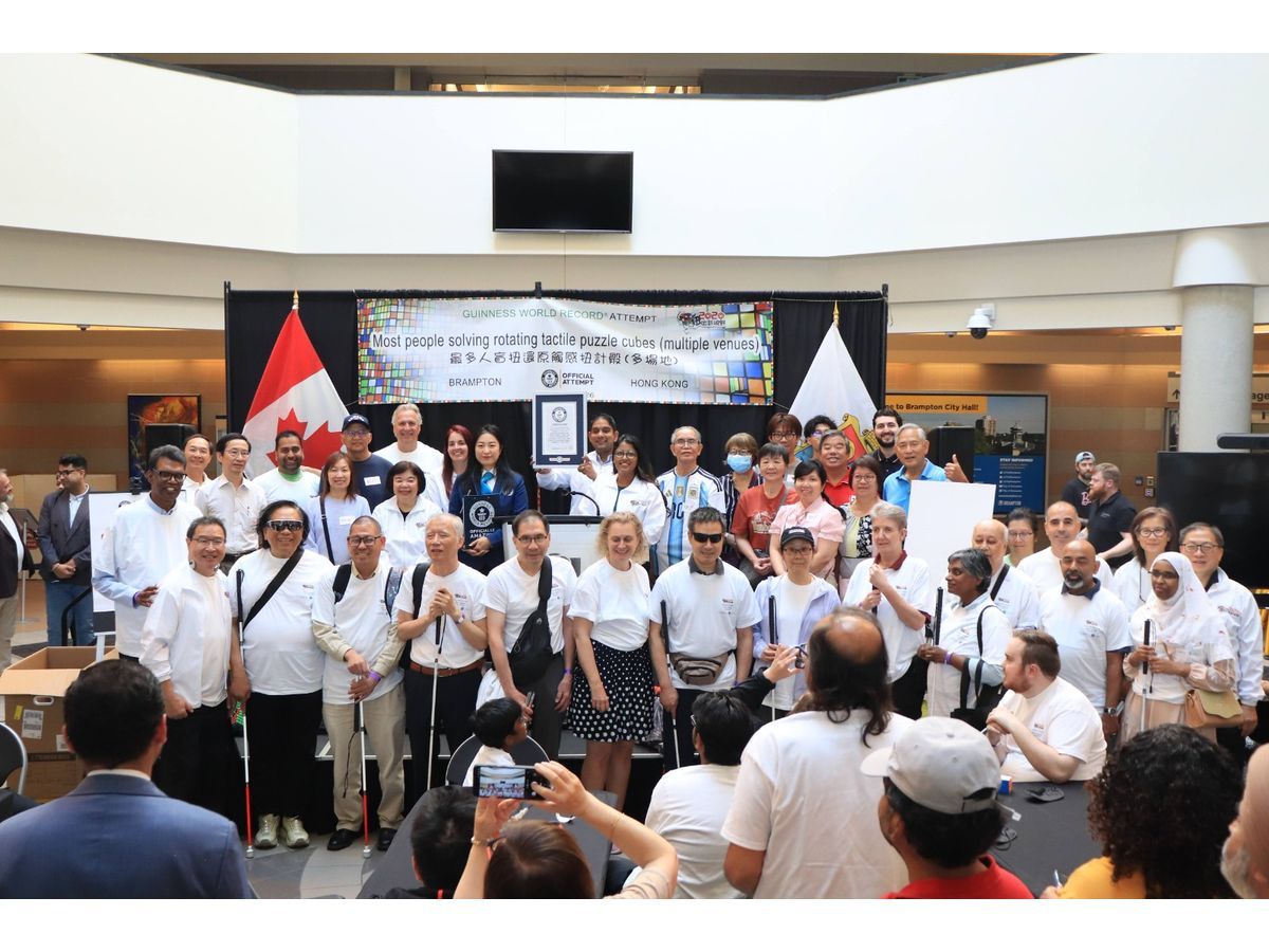Participants, organizers, volunteers and supporters gather at Brampton City Hall following the Guinness World Records achievement for the Most People Solving Rotating Tactile Puzzle Cubes at Multiple Venues, held jointly with Hong Kong SAR, China, on July 11, 2026.