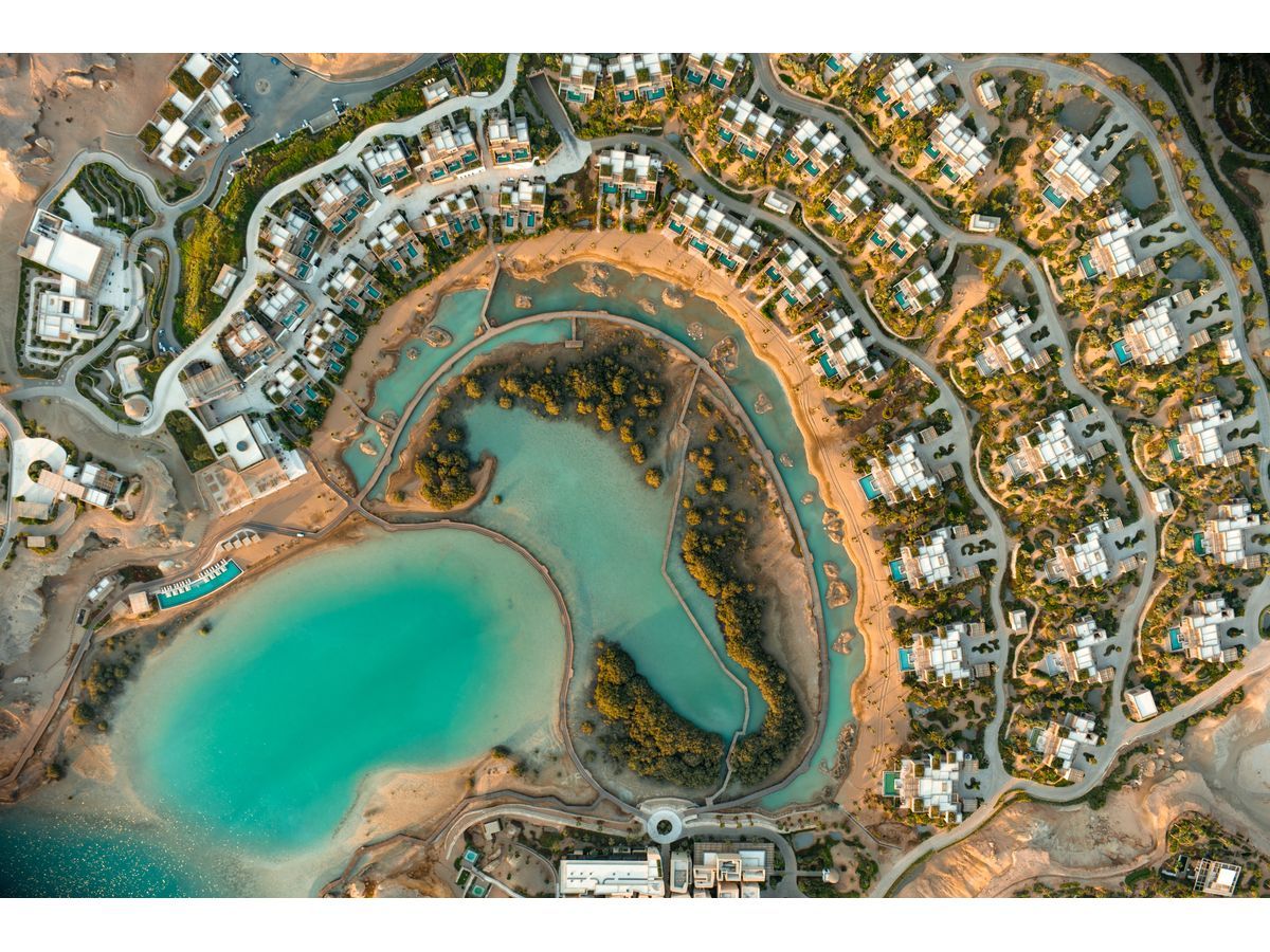 An aerial view of Six Senses AMAALA and its surrounding shoreline at Triple Bay