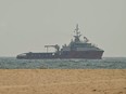 A ship sails off the coast of Ajman on July 10. Traffic through the Strait of Hormuz has fallen sharply since July 8, especially through the UN-backed Omani route, analysts said, after vessels were attacked earlier this week and as the United States and Iran traded renewed strikes.