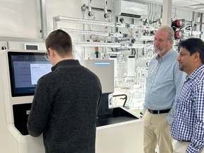 From left, High Q Technologies’ applications manager Austin Gamble‑Jarvi, managing director Don Carkner and director of product marketing Rudra Maharajh conduct system checks on a Fathom pulsed electron paramagnetic resonance installation in the United Kingdom.