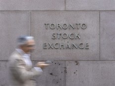 A pedestrian walks past Toronto Stock Exchange signage in Toronto’s Financial District.