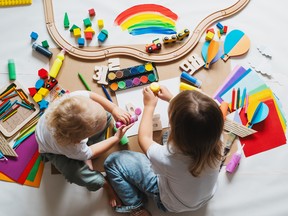 Children drawing and making crafts in kindergarten or daycare.