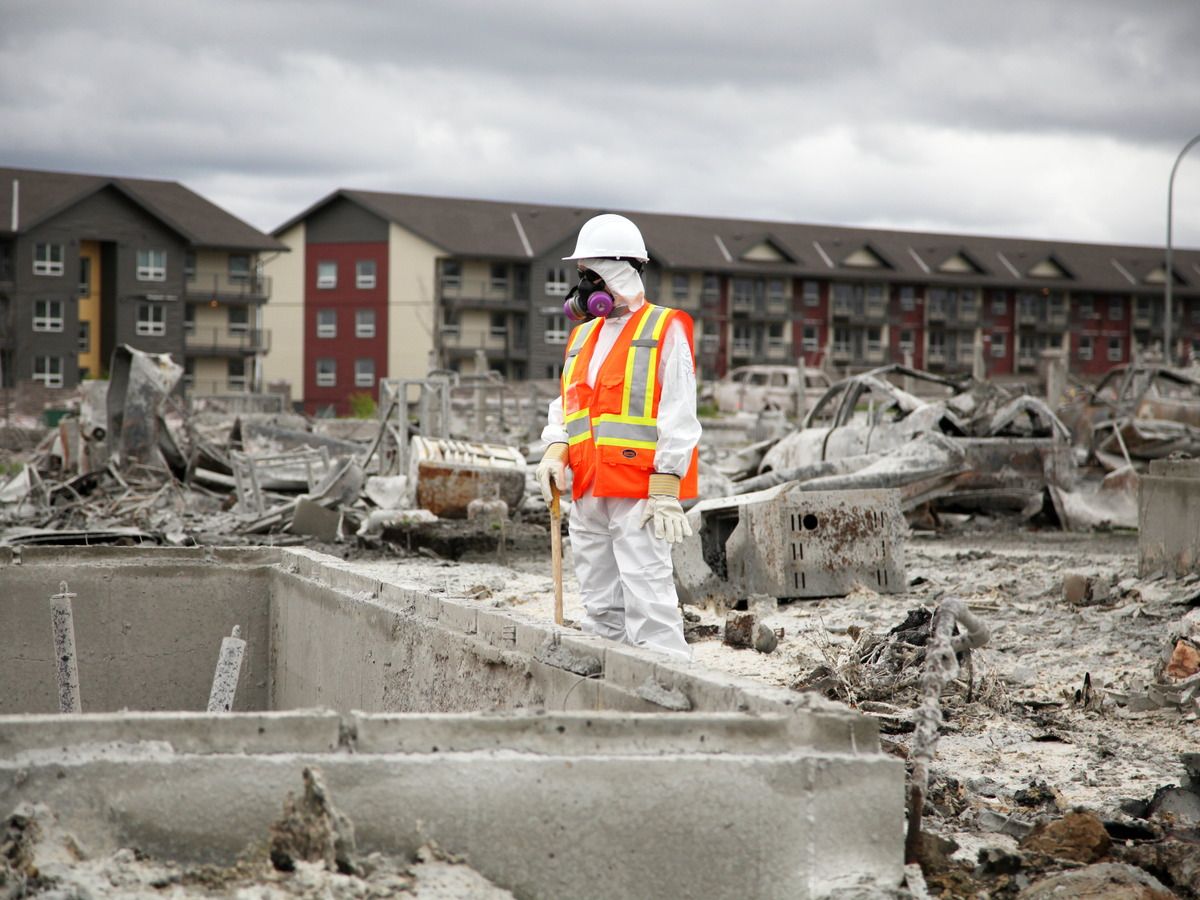 Team Rubicon member pauses between sifting through the remains of a home on Prospect Drive in Fort McMurray's Timberlea neighbourhood on June 12, 2016.