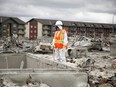 Team Rubicon member pauses between sifting through the remains of a home on Prospect Drive in Fort McMurray's Timberlea neighbourhood on June 12, 2016.