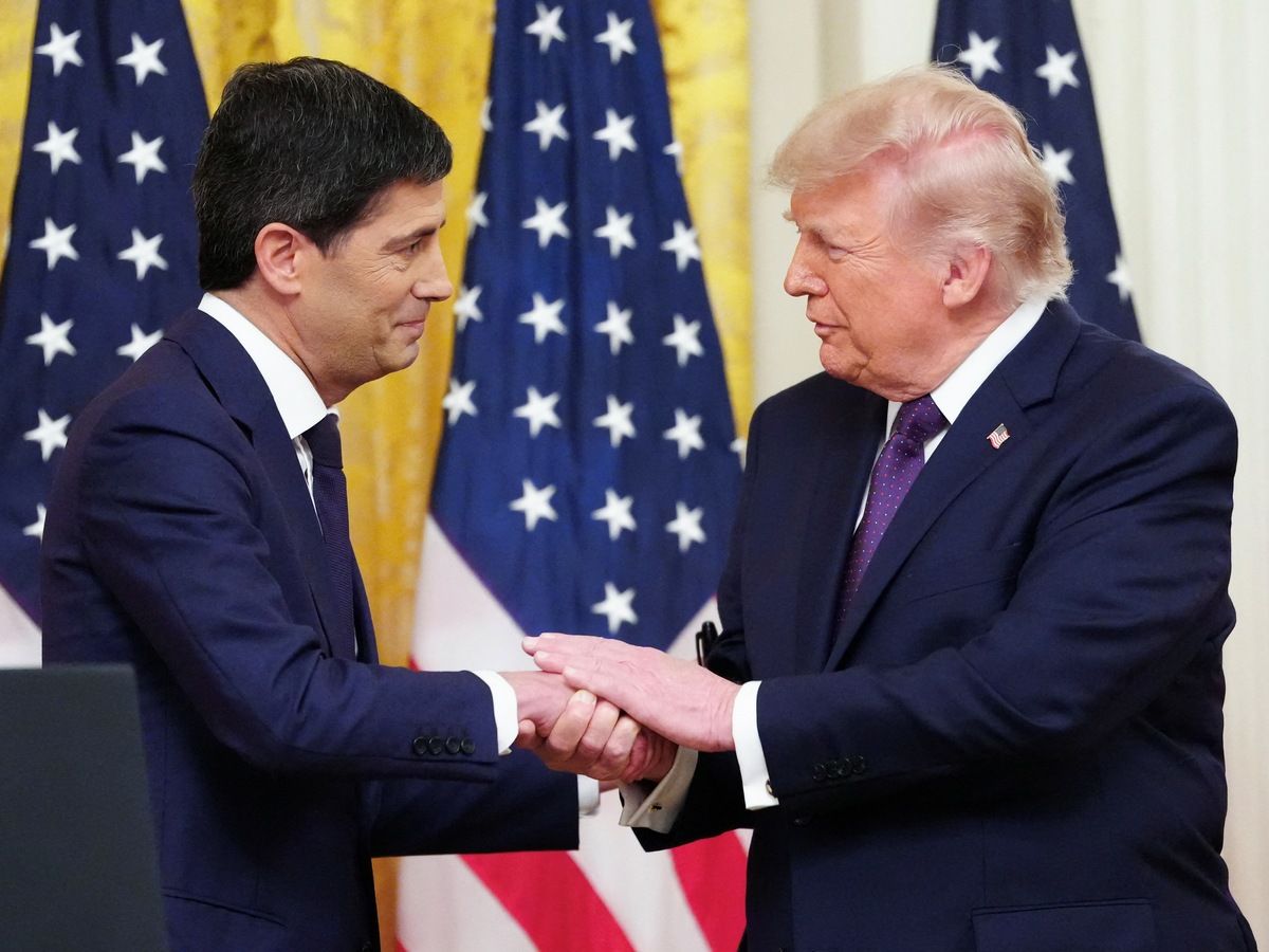 US President Donald Trump shakes hands with the new Chairman of the Federal Reserve Kevin Warsh (L) during a swearing in ceremony in the East Room of the White House in Washington, DC on May 22, 2026.