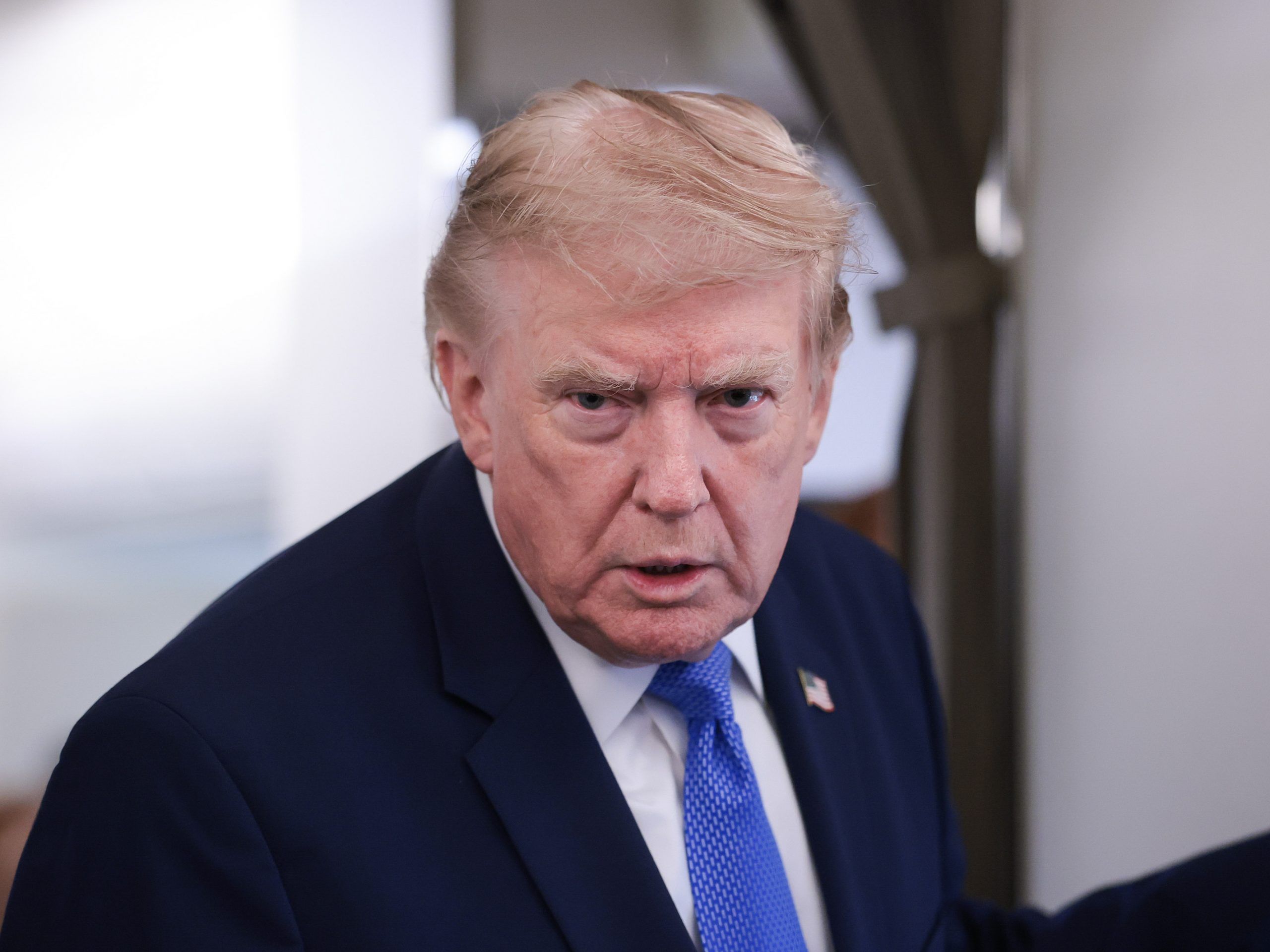 U.S. President Donald Trump speaks to reporters aboard Air Force One on August 02, 2026 on a return flight to Joint Base Andrews, Maryland.
