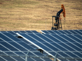 An oil pumpjack behind a bank of solar panels near Longview, Alberta, Canada, on Tuesday, April 26, 2022.