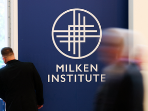 Attendees walk past signage of the Milken Institute during the 29th annual Milken Institute Global Conference at the Beverly Hilton in Beverly Hills, California on May 5, 2026.
