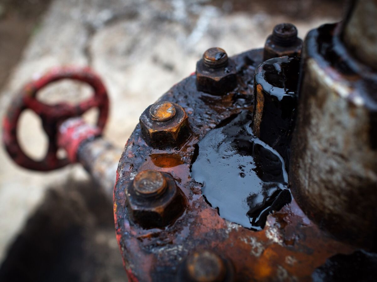 Crude oil leaks from an oil pumping jack in an oil field Russia.