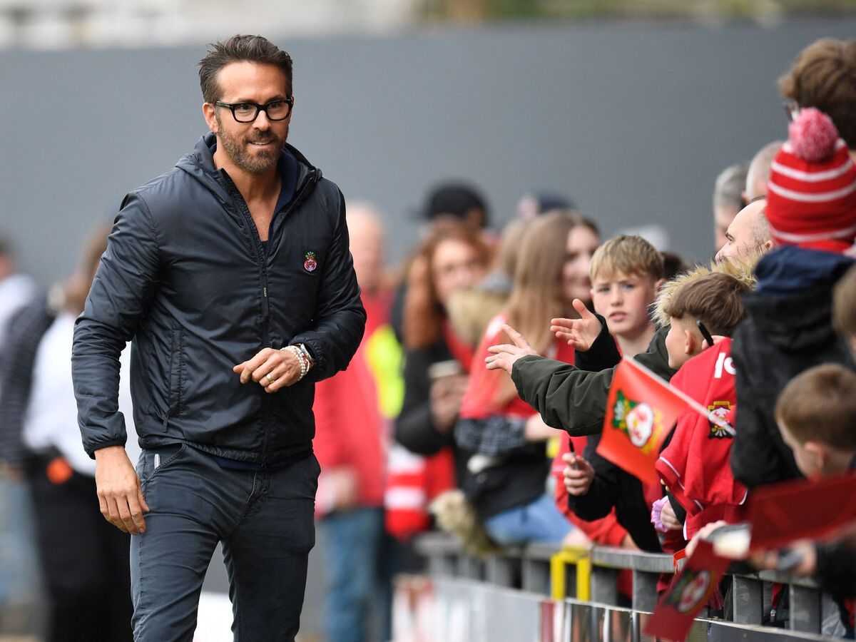 Actor and Wrexham owner Ryan Reynolds walks pitch-side ahead of the English National League football match between Wrexham and Boreham Wood at the Racecourse Ground Stadium in Wrexham, north Wales, on April 22, 2023.